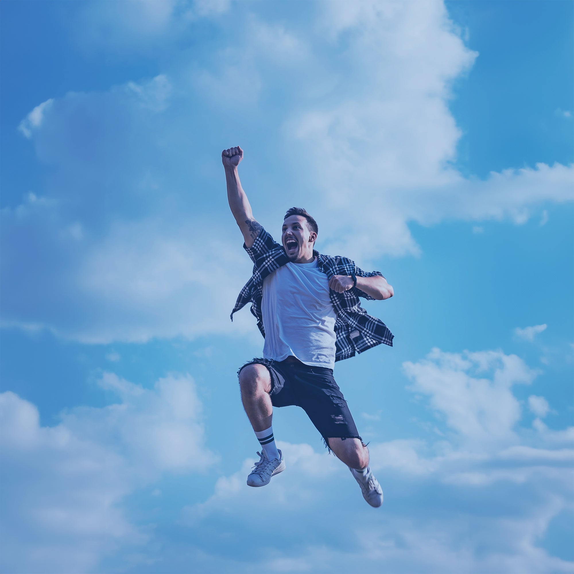 Fellow Jumping with clouds in the background