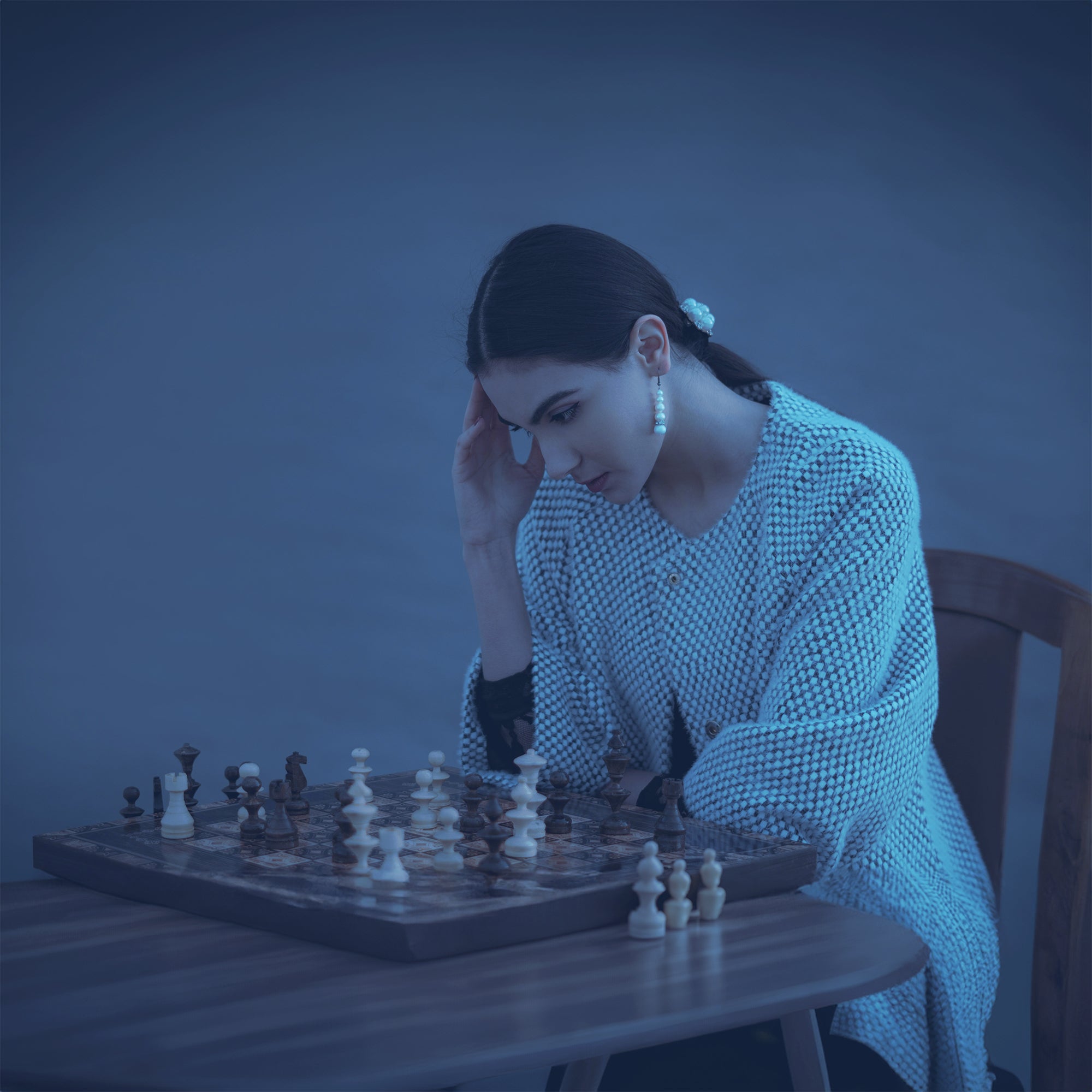 A lady playing a game of chess