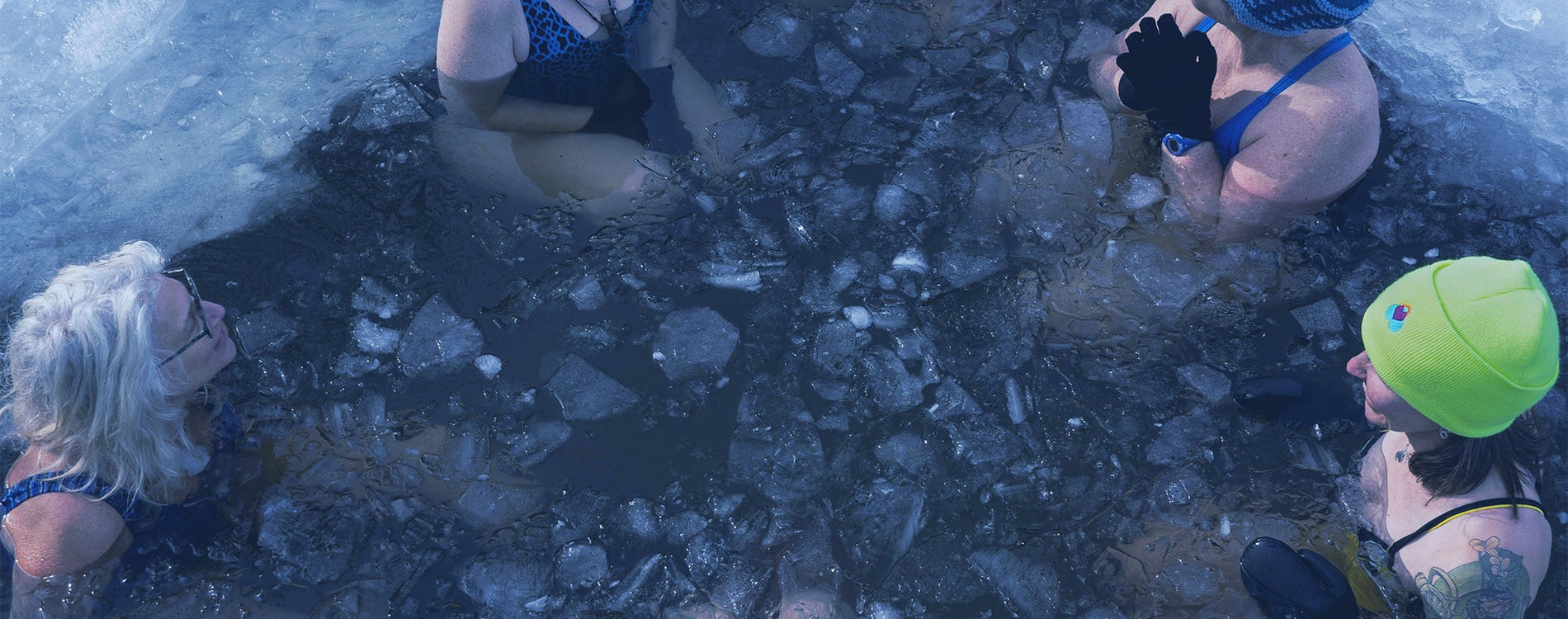 Several Ladies Sitting in a Lake or Pond with Ice all around them