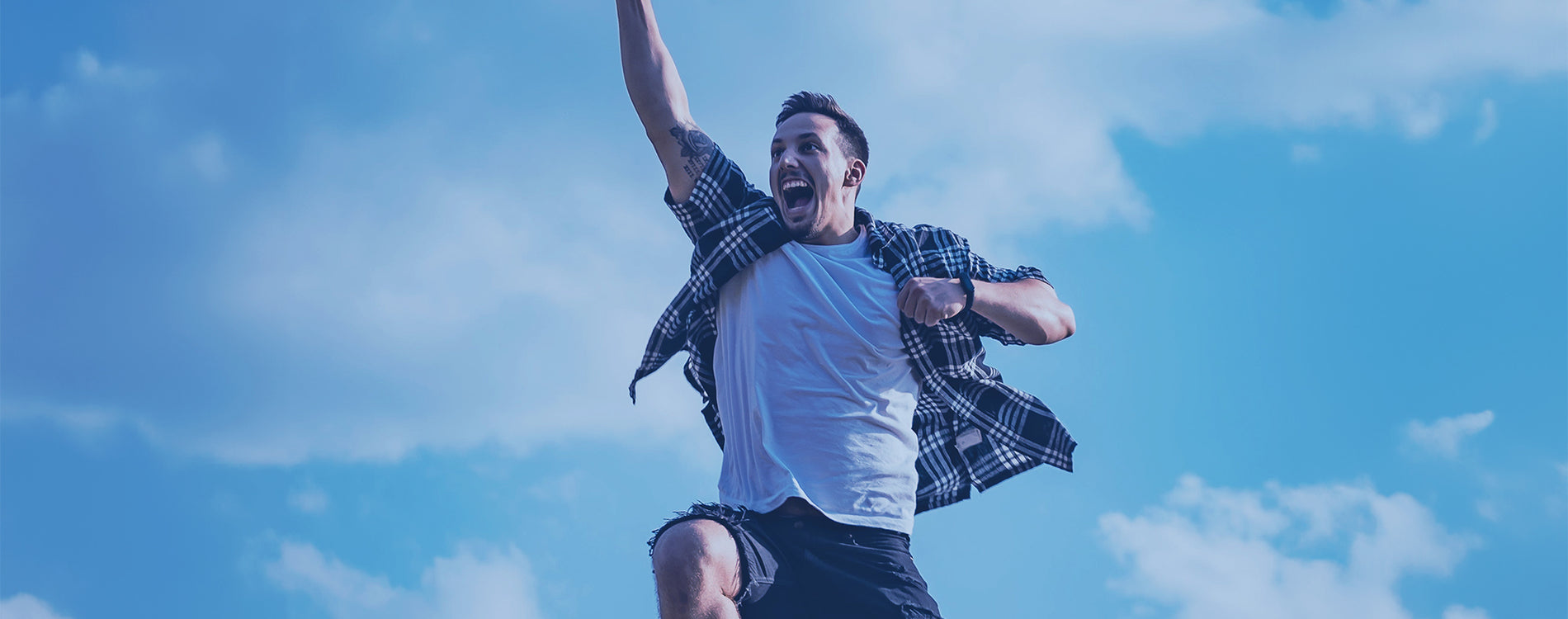 Fellow Jumping with clouds in the background