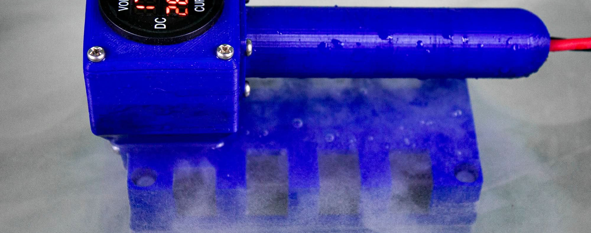 IonizeMe Maxx Array in a foot bath with a lot of bubbles coming from it showing that electrolysis is occurring.  The meter on the array shows 17.4 Volts and 2.8 Amps