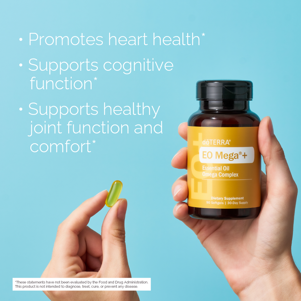 EO Mega+ diatary supplement bottle Essential Oil Omega Complex  held by a hand with a blue background