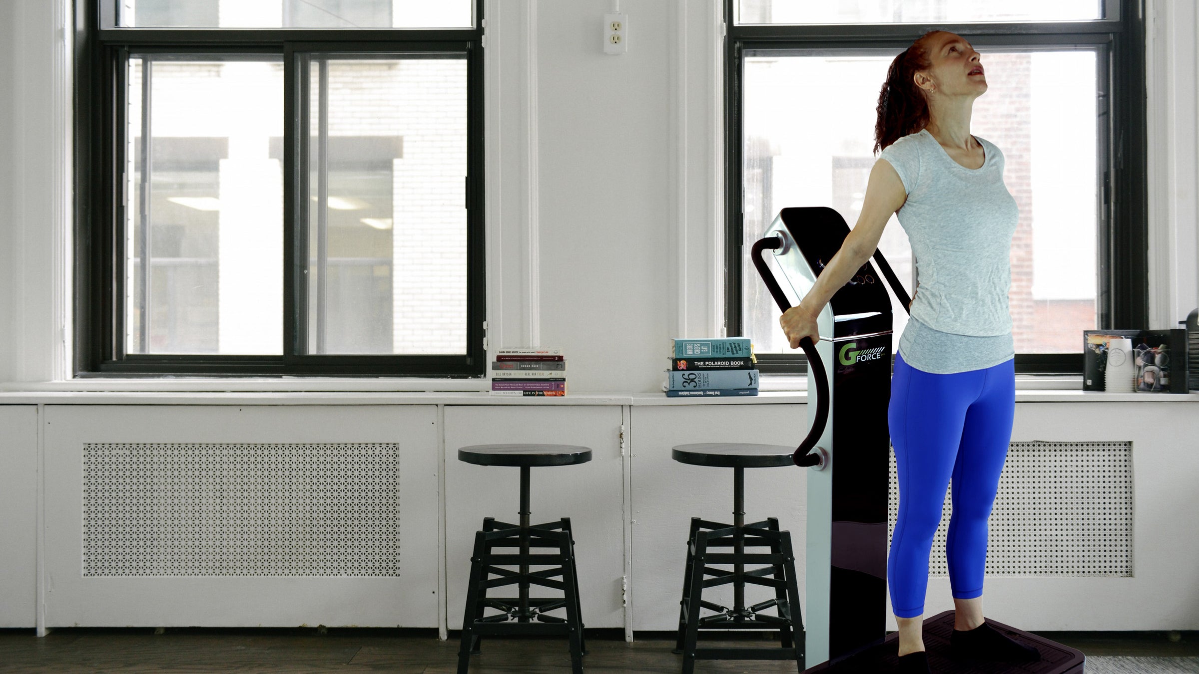 Woman standing on GForce Professional Whole Body Vibration Machine