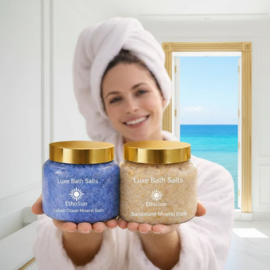 Woman holding two jars of Luxe Bath Salts with a beach scene in the background