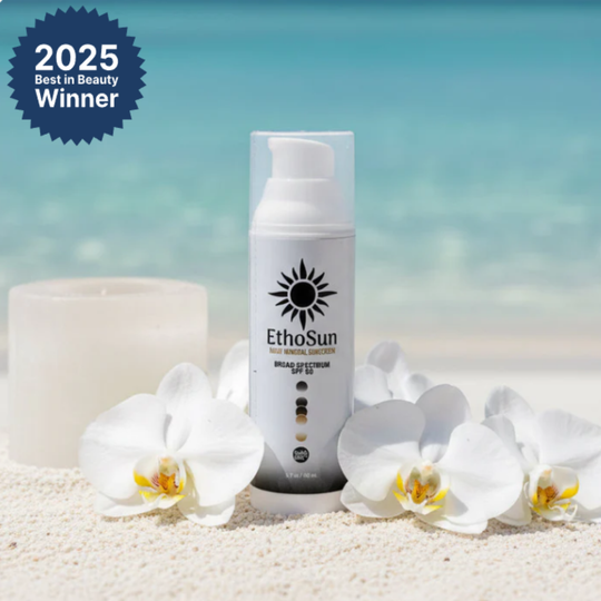 2025 Best in Beauty Winner EthoSun Daily Mineral Sunscreen Broad Spectrum SPF 50 in Bottle with candle and white petals background