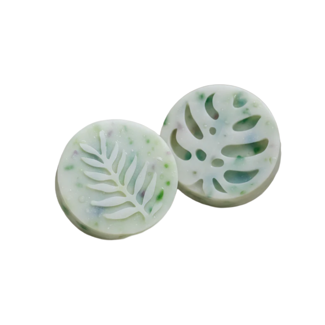 Two silicone molds with leaf patterns on a white background