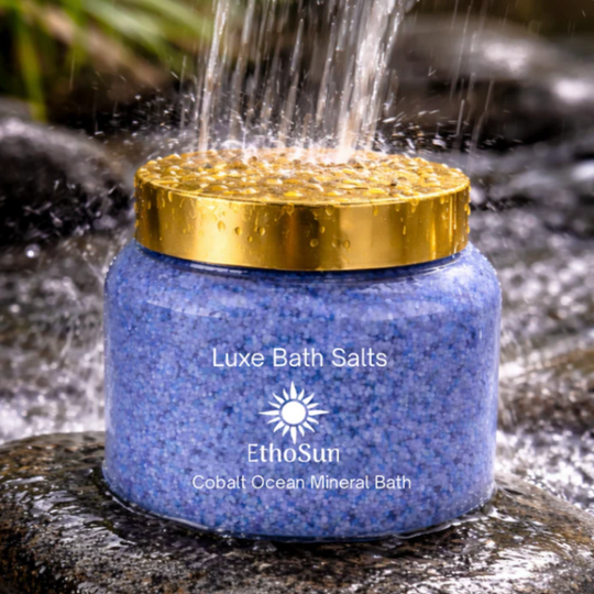 Blue jar of Luxe Bath Salts with gold lid on a natural background
