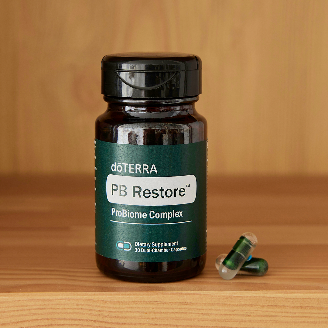doTERRA PB Restore ProBiome Complex supplement bottle on a wooden surface