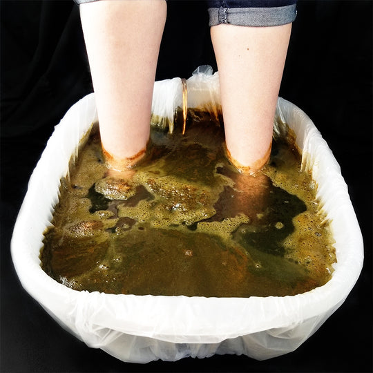 Foot Tub Basin with Feet in Water.  Detox Session is being performed and water looks brown and green.