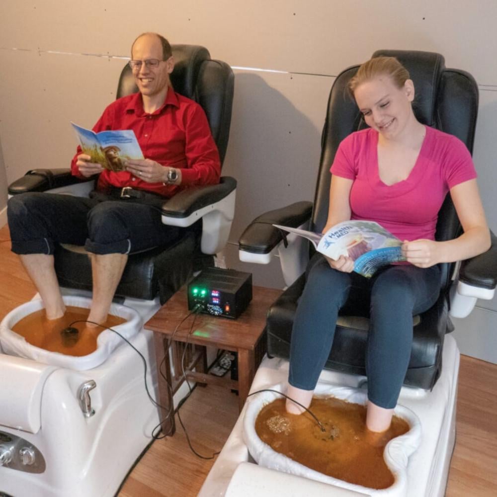 Man and Woman Using IonizeMe Maxx Dual Ionic Detox Foot Bath System